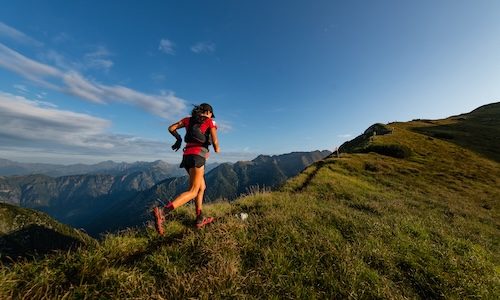 Sporty mountain woman rides in trail during endurance trail